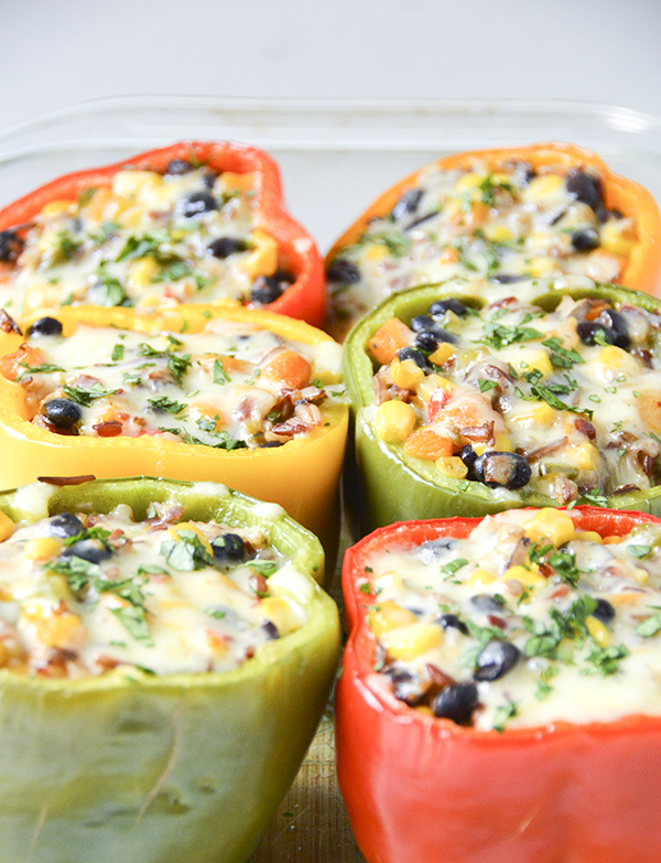 Southwestern Stuffed Bell Peppers - This delicious recipe is packed with flavor and vegetarian (or easily vegan). Try it this week! #vegetarian #recipe #plantbased #stuffedpeppers #southwestern