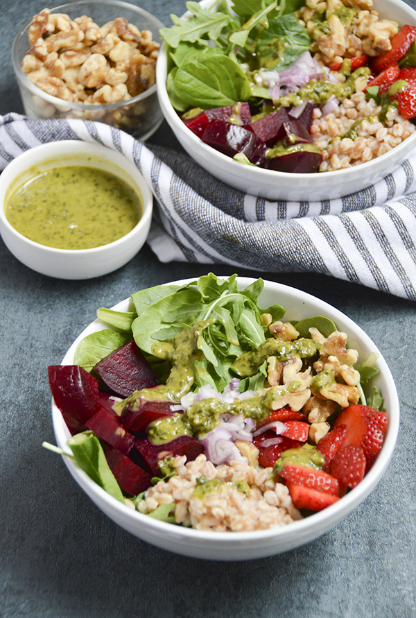 Roasted Beet & Walnut Grain Bowl - This hearty grain bowl is made with roasted beets, farro, strawberries, walnuts, arugula and topped with a delicious basil vinaigrette. #buddhabowl #grainbowl #healthyrecipe #vegetarian #plantbased